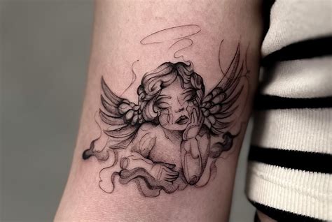 cherub angels tattoos|angel holding baby tattoo.